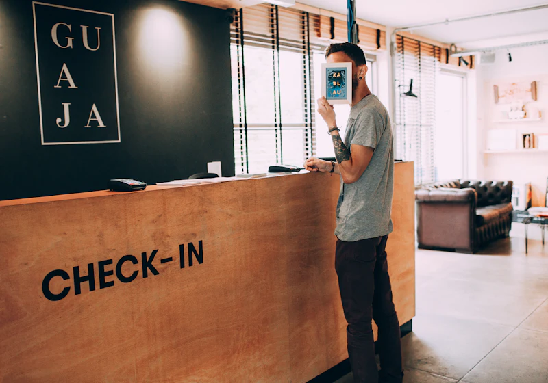 A person standing at an office reception counter.