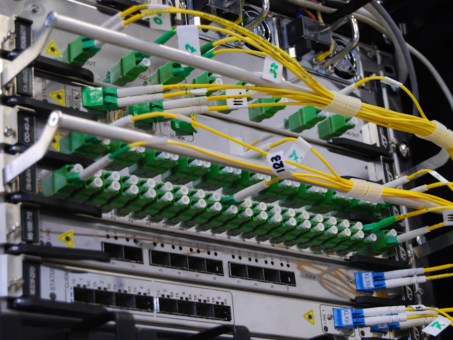 Fibre and copper patch leads terminated into a network switch in a cabinet.
