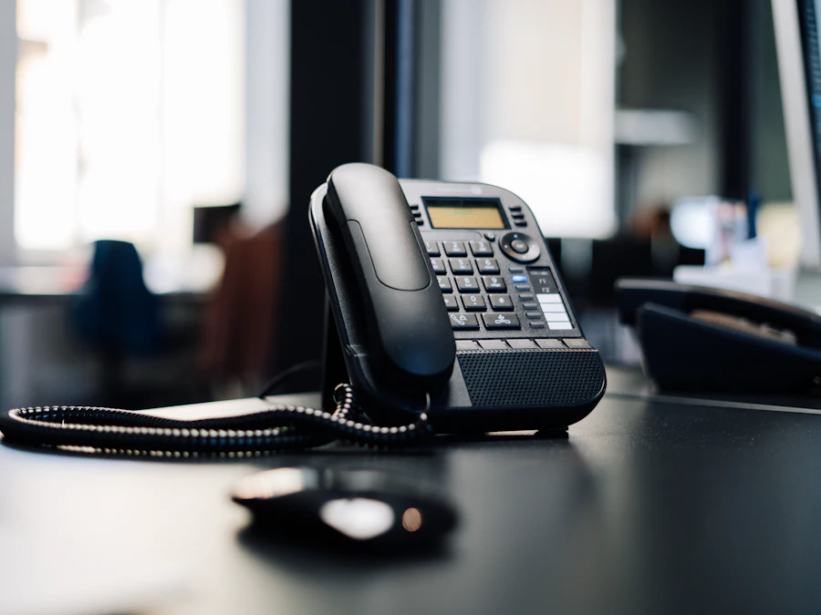 An IP desk telephone with a handset and keypad on a desk.